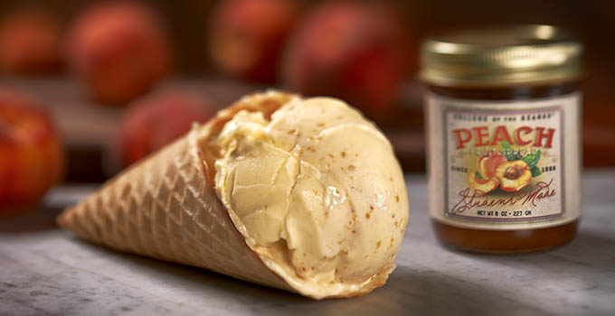 Ice cream in waffle cone and a jar of peach fruit spread