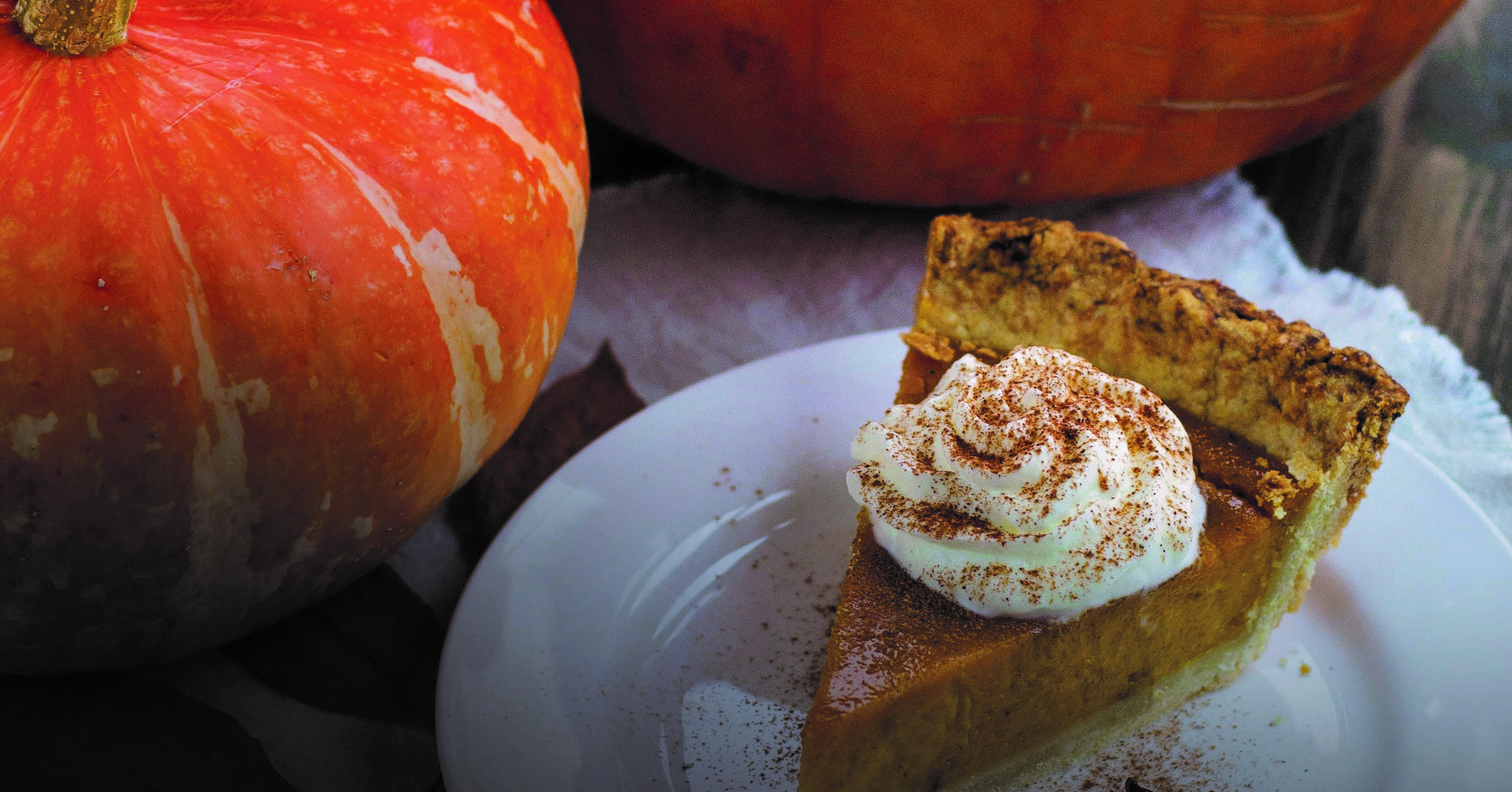 Pumpkins and pumpkin pie with whipped cream